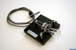 A commercially manufactured paddle used in conjunction with an electronic keyer to generate high-speed Morse code.