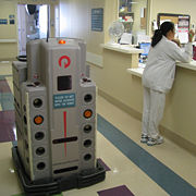 HelpMate trackless pharmacy bot navigates autonomously to transport drugs, lab specimens, supplies and medical records.