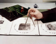 A member of the Royal Canadian Mounted Police demonstrates the location of ridge endings, bifurcations and dots.