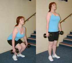 An individual performing a dumbbell squat.