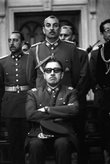 Augusto Pinochet sits with sunglasses in the front of the Chilean Junta