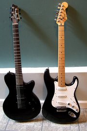 Both the North America-built Godin LG (left) and the South Korean Fender Squier Stratocaster (right) are solidbody electric guitars, but they differ significantly in design, including scale length, neck and body woods, and pickup type.