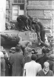 A Soviet T-34 tank being examined by curious citizens in the 1956 Hungarian Revolution
