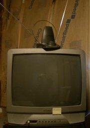 A television with a VHF "rabbit ears" antenna and a loop UHF antenna.
