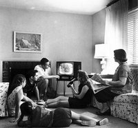 An American family watching television in the 1950's.
