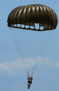 An American Paratrooper using a T-10C series 'round' parachute