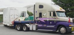 Road tractor pulling a flatbed trailer