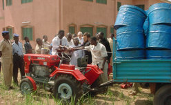 A small red tractor towing a cargo cart