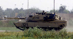 An M1 Abrams tank on lookout. Heat haze from the turbine engine can be seen to the rear. Photo from US Army Combined Joint Task Force Seven.