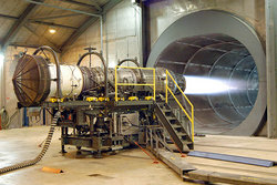A Pratt and Whitney turbofan engine for the F-15 Eagle is tested at Robins Air Force Base, Georgia, USA. The tunnel behind the engine muffles noise and allows exhaust to escape. The mesh cover at the front of the engine (left of photo) prevents debris - or people - from being pulled into the engine by the huge volume of air rushing into the inlet.