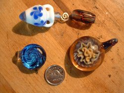 Hand-blown glass beads and pendants illustrate some of the myriad colors and shapes of glass art (The   is for .)