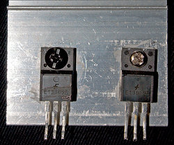 High-power transistors used in a switching power supply. Mounted on an aluminium heat sink for enhanced cooling.