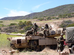 An M1 Abrams engine undergoing maintenance by the crew, with the turret turned sideways to expose the engine deck. Photo from B Company, 4th Tank Battalion, 4th Marine Division, US Marines.