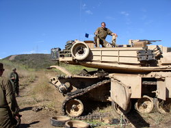 Sections of the side-skirt are swung aside on this M1 Abrams tank to expose the track so that a road wheel can be replaced. Photo from B Company, 4th Tank Battalion, 4th Marine Division, US Marines.