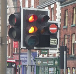 Traffic lights can have several additional lights for filter turns or bus lanes. This one shows the distinctive red + amber combination seen in the UK.