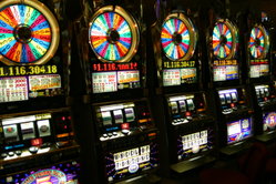 A row of "Wheel of Fortune" slot machines in a casino in Las Vegas. This specific slot machine is loosely based on the TV game show Wheel of Fortune