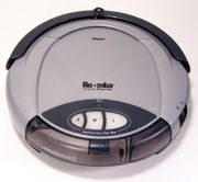 First generation Roomba vacuums the carpets in a domestic environment